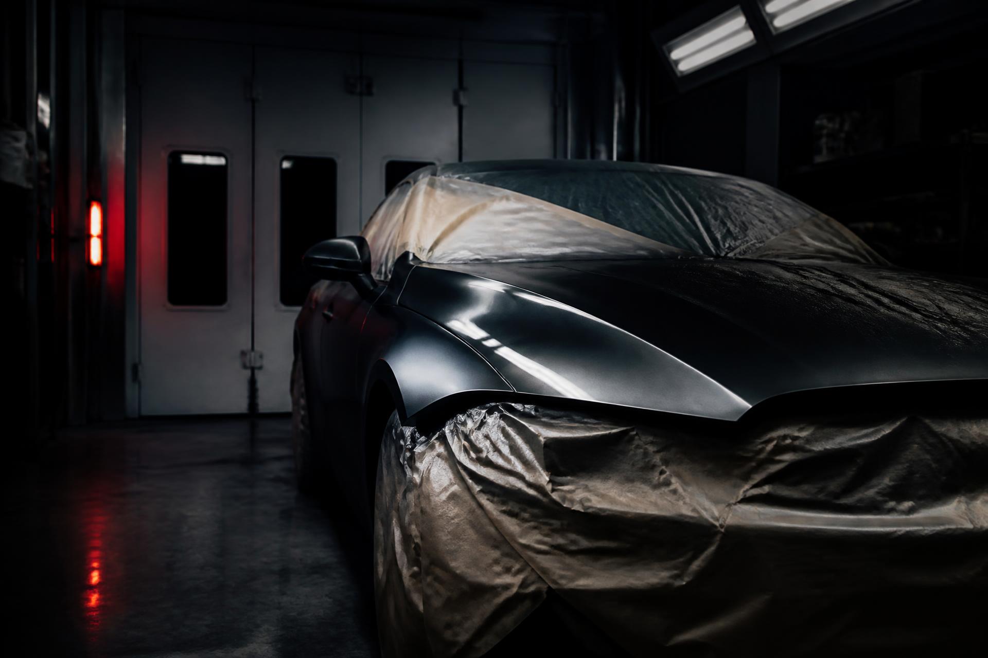 Car under workshop lighting in the VI&NI body repair and paint workshop in Portadown